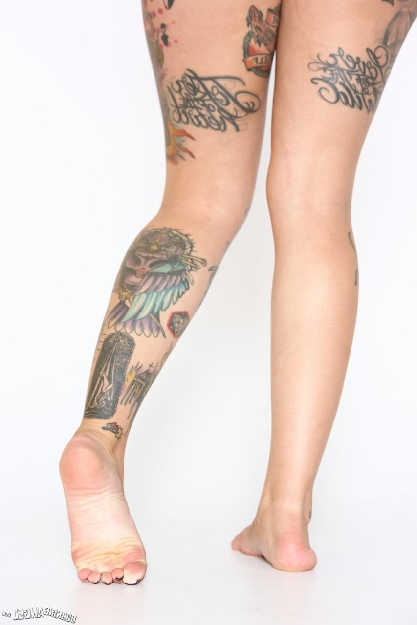 17P Alt model with a big butt and a half-shaved head exposes her tattooed body