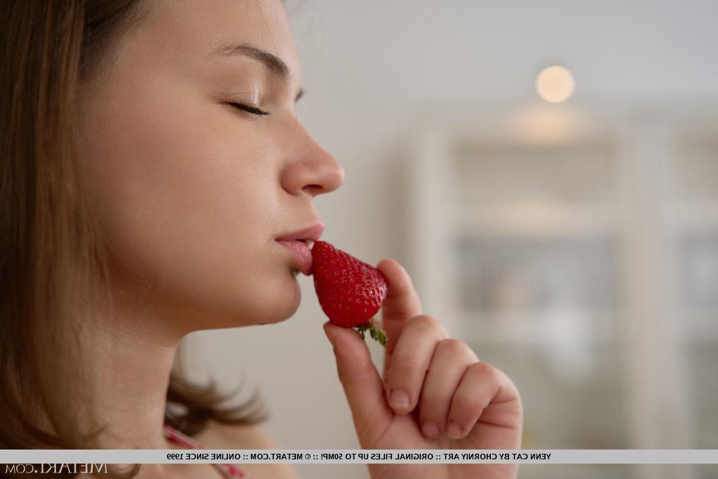 18P Young girl Yenn Cat gets totally naked while eating strawberries in a kitchen