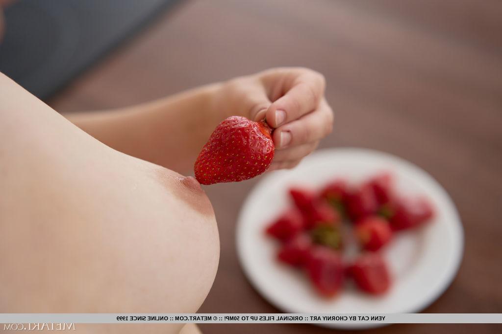 18P Young girl Yenn Cat gets totally naked while eating strawberries in a kitchen
