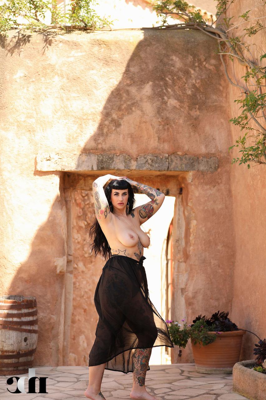20P Raven haired babe Cherrie Pie reveals her tattoos and huge boobs outdoors
