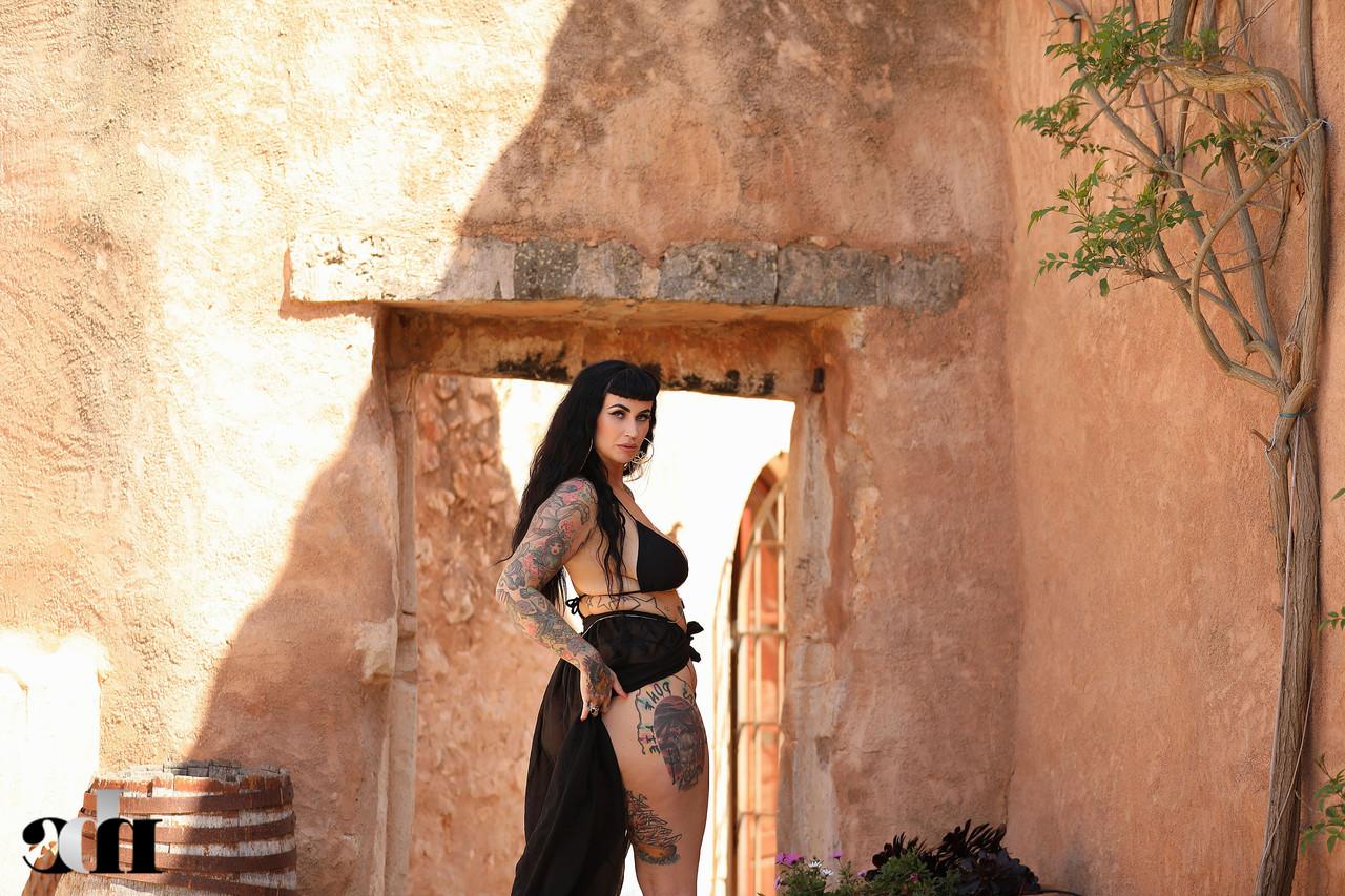 20P Raven haired babe Cherrie Pie reveals her tattoos and huge boobs outdoors