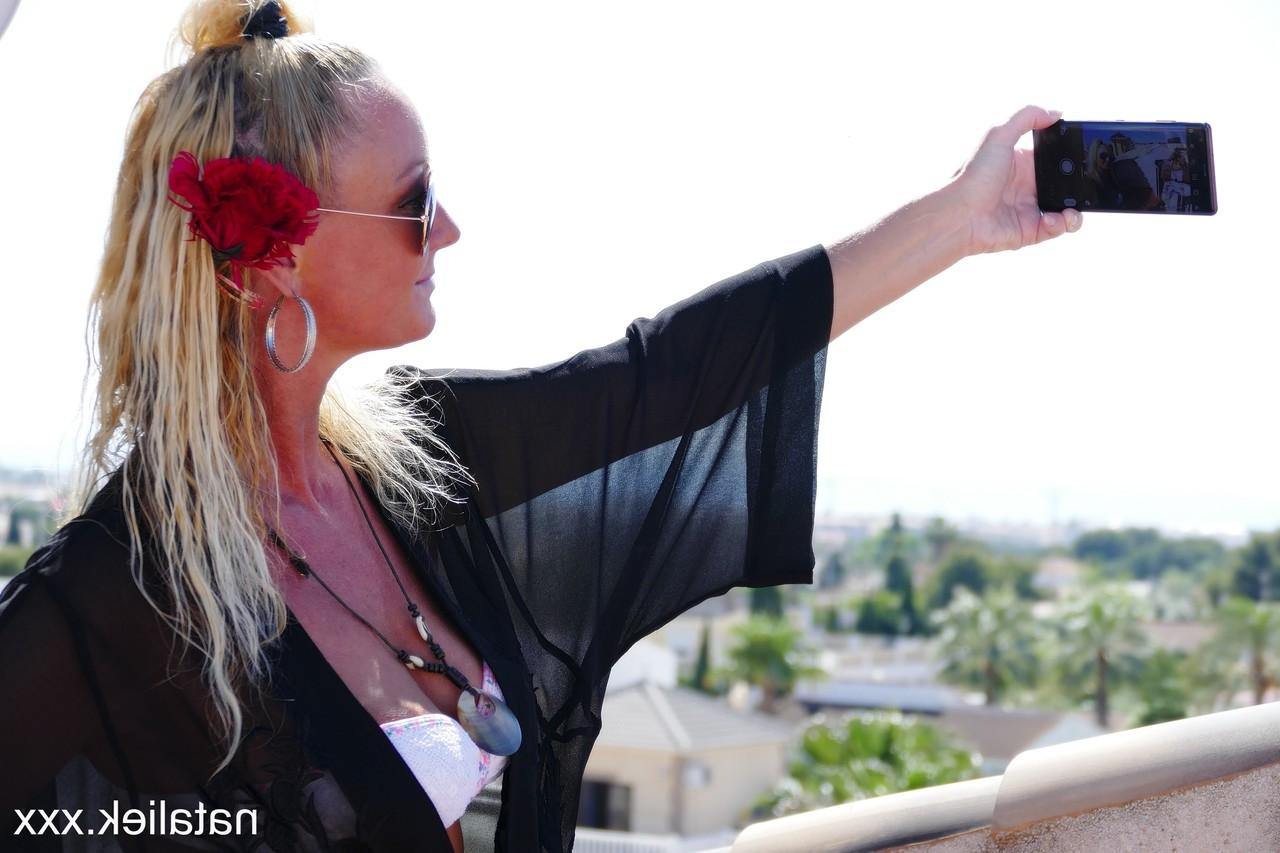15P Slutty Spanish MILF Natalie K takes selfies of her pussy & tits on the balcony
