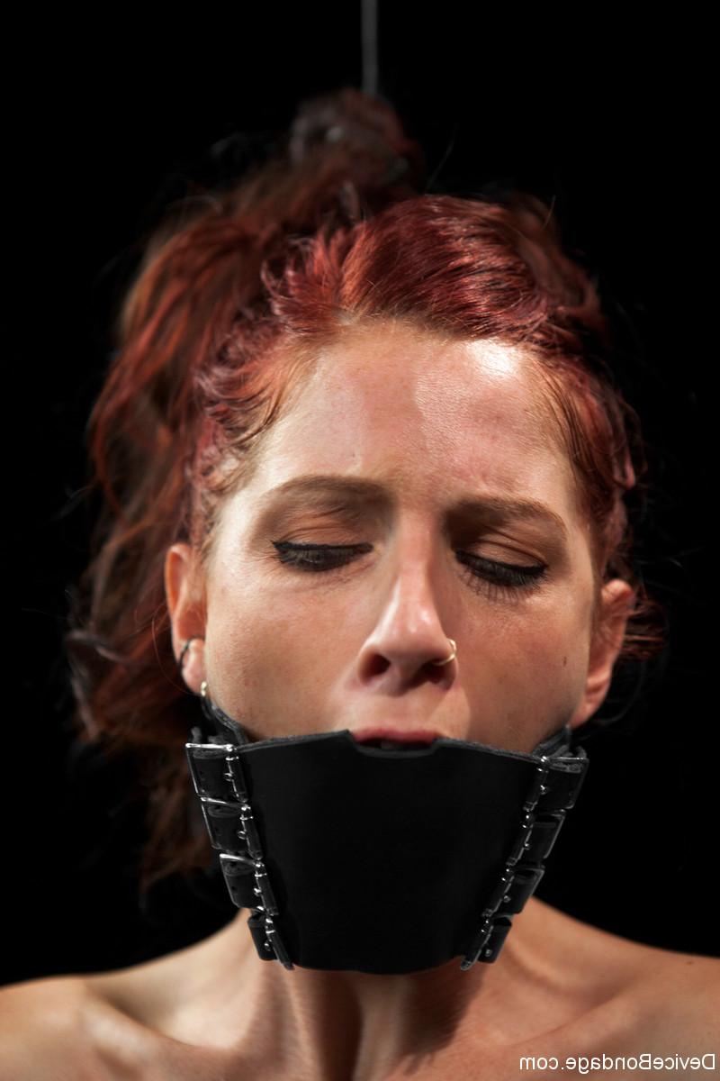 17P Redheaded sex slave is held in chains while being whipped and masturbated