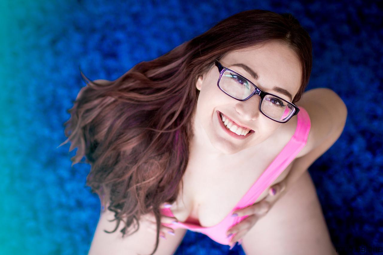15P Brunette nerd with a big ass Arielle Cleo poses in an alluring pink swimsuit