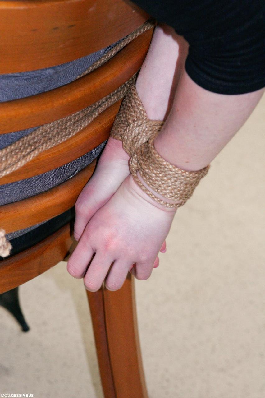 20P Fully clothed gagged babe Lilly struggles to be free of her rope bondage