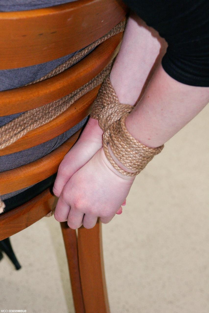 20P Fully clothed gagged babe Lilly struggles to be free of her rope bondage