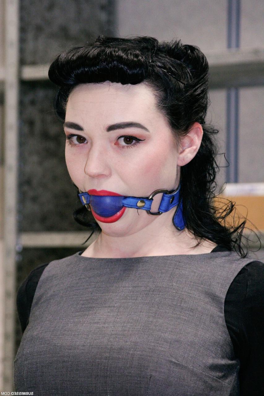 20P Fully clothed gagged babe Lilly struggles to be free of her rope bondage