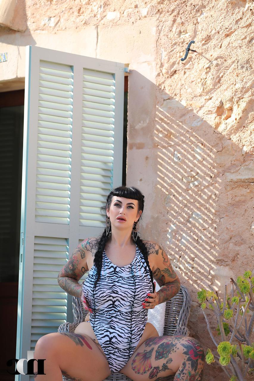 20P Tattooed babe Cherrie Pie shows off her juicy tits and her big booty outdoors