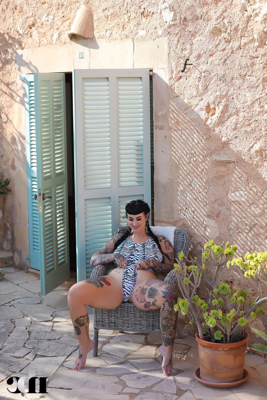 20P Tattooed babe Cherrie Pie shows off her juicy tits and her big booty outdoors
