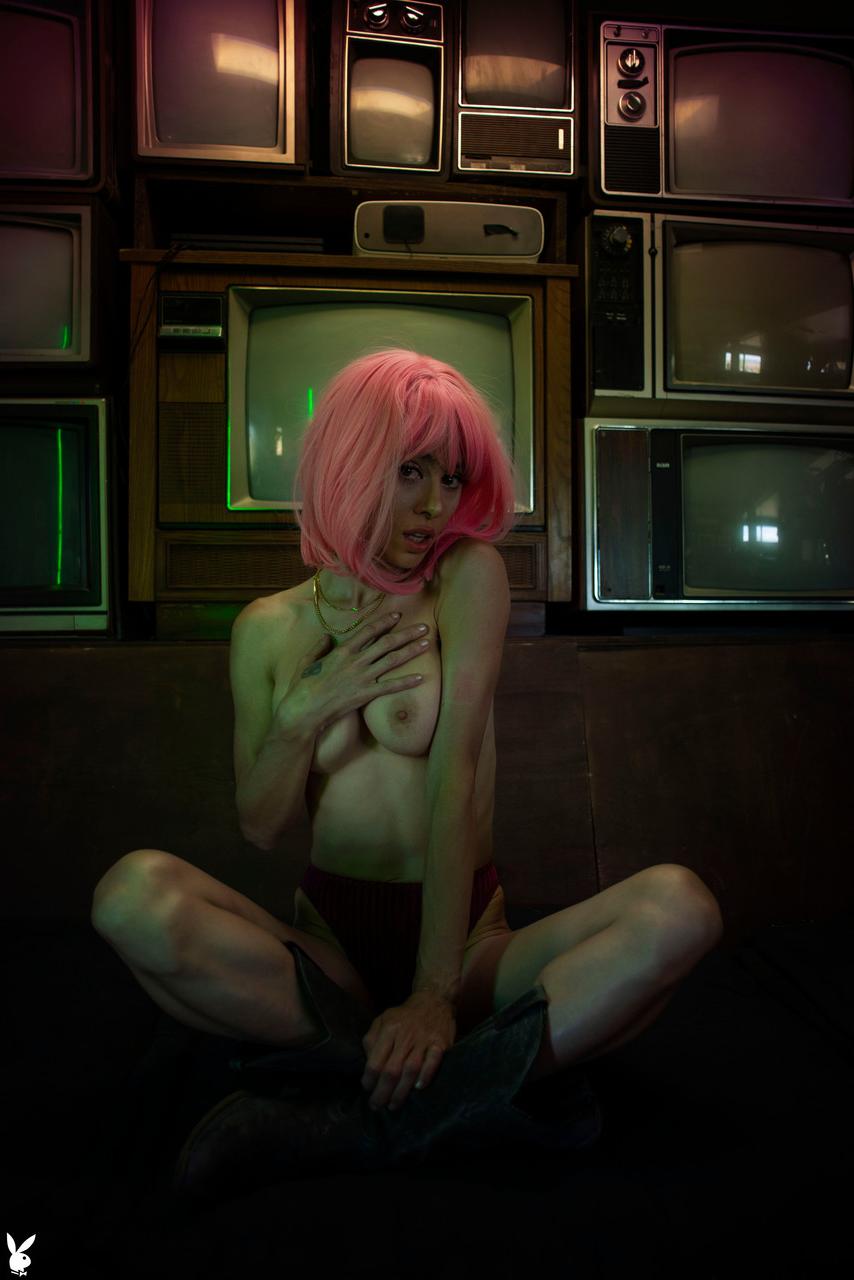 20P Pink haired babe with big tits Noel Leon undresses and poses in front of TVs