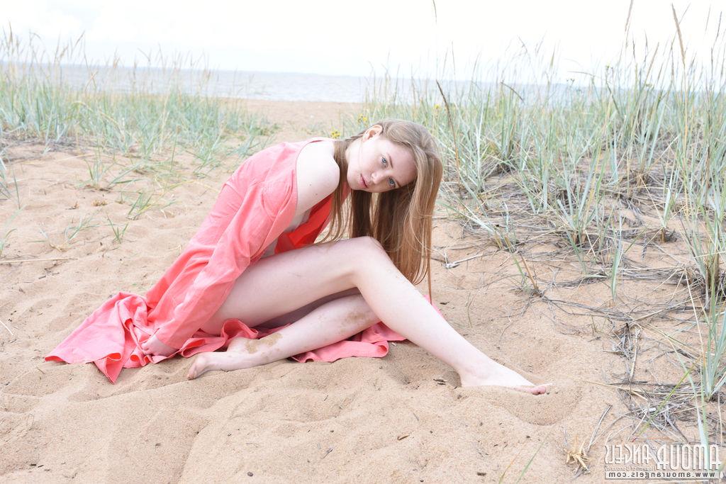 20P Die hellhäutige Teenagerin Gerda zieht sich auf einem Sandfleck am Meer nackt aus