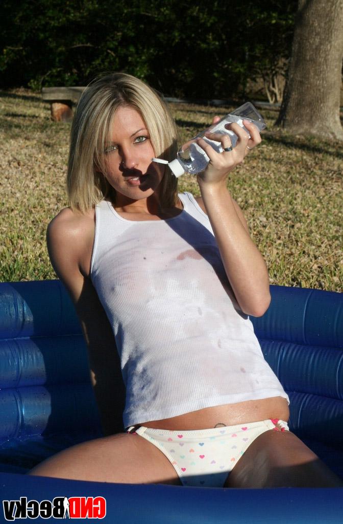 12P Blonde teen covers her small tits in baby oil outdoors in a wading pool