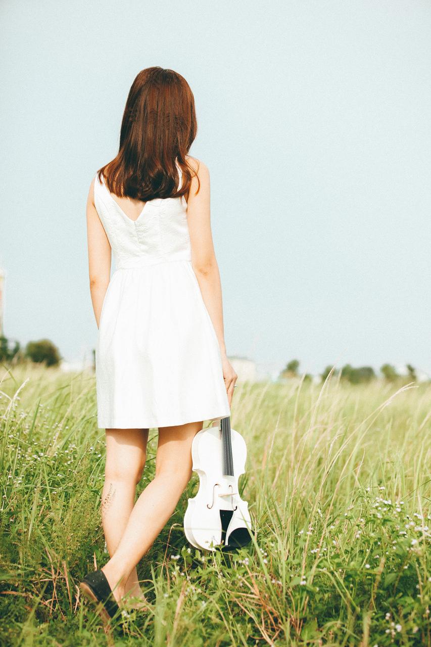20P Cute Asian musician poses in her white dress while playing a violin outside