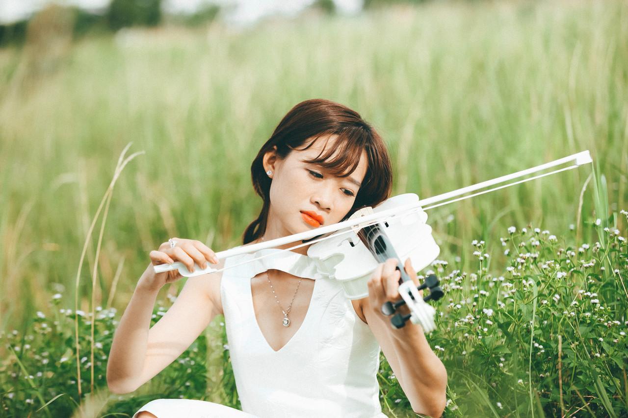 20P Cute Asian musician poses in her white dress while playing a violin outside