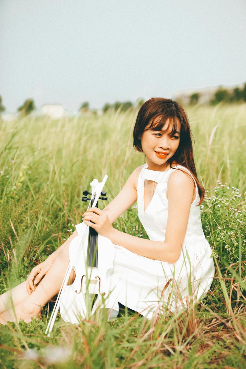 20P Cute Asian musician poses in her white dress while playing a violin outside