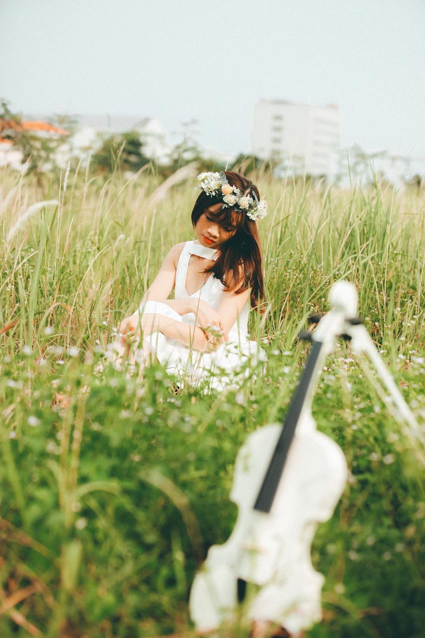 20P Cute Asian musician poses in her white dress while playing a violin outside