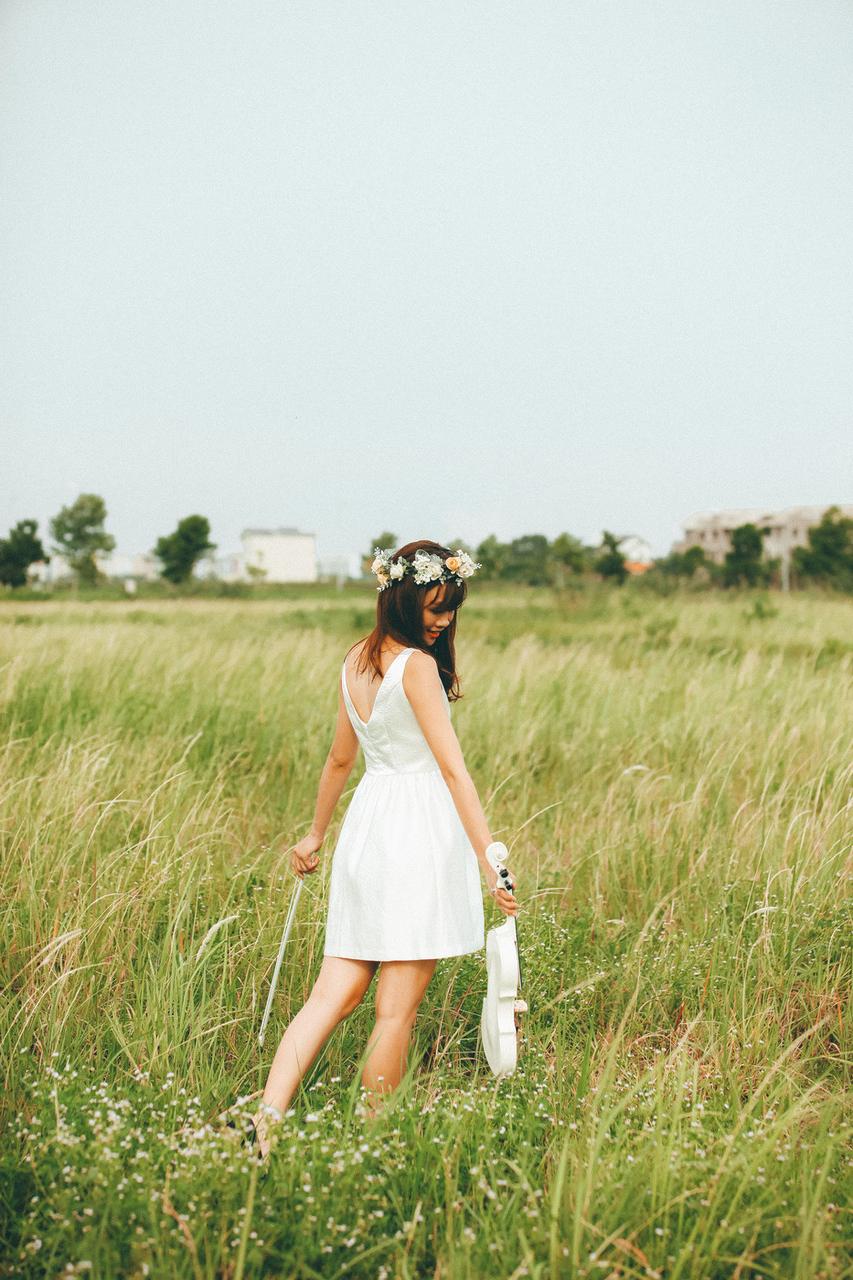 20P Cute Asian musician poses in her white dress while playing a violin outside