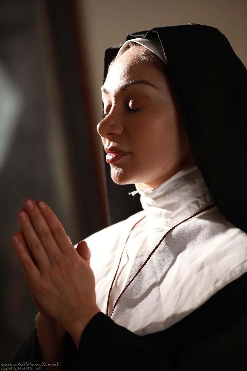 20P Naughty nun in white stockings Lea Lexis strips and masturbates on the floor