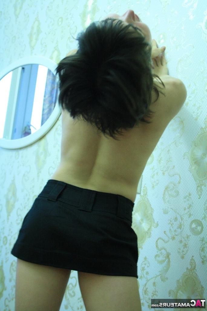 16P Petite brunette Malika shows her almost flat chest in a black miniskirt