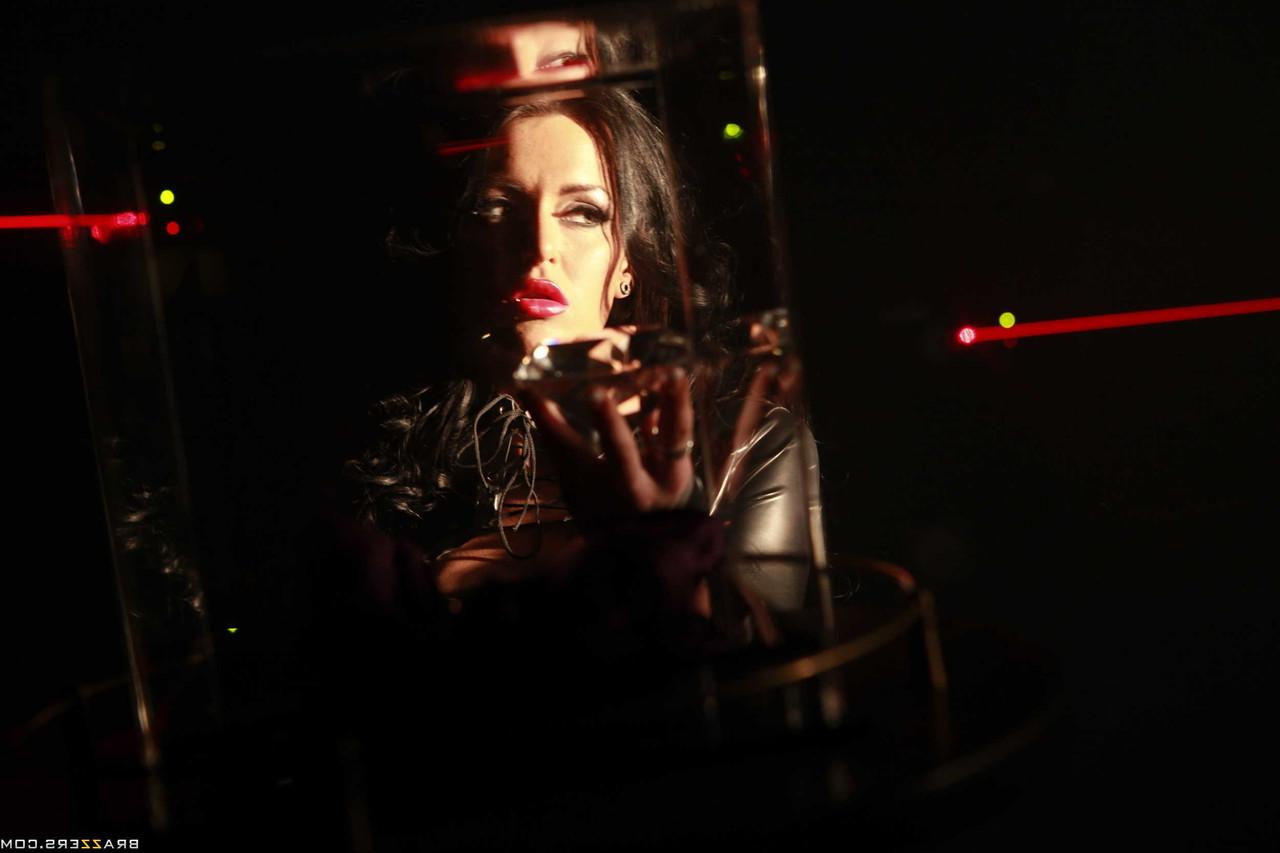 17P Busty leather clad criminal Stacey Lacey shows deep cleavage while thieving