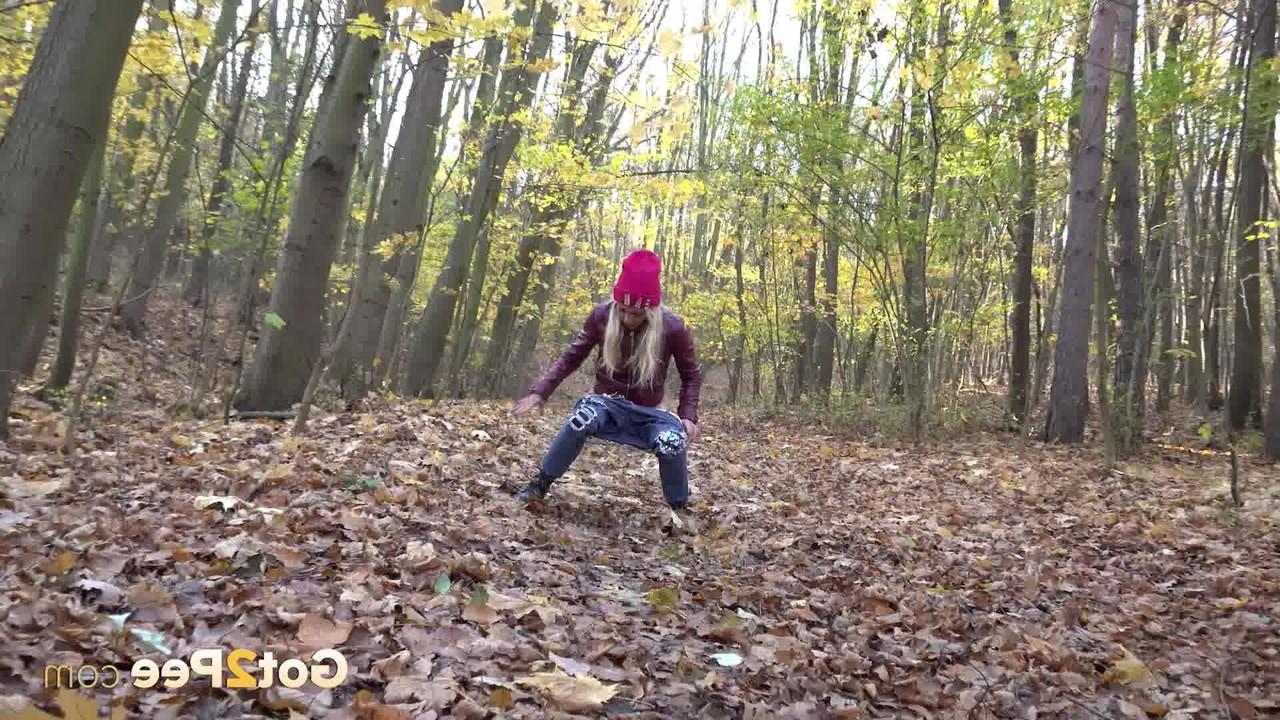 15P Blonde girl Caroli pulls down her jeans to pee on leaves in the woods
