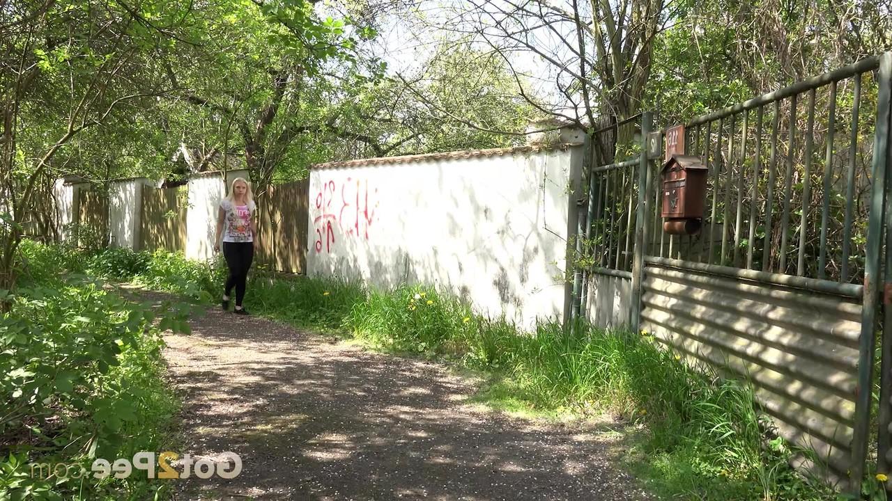 15P Distressed blond Morena squats for an urgent pee outside a fenced yard