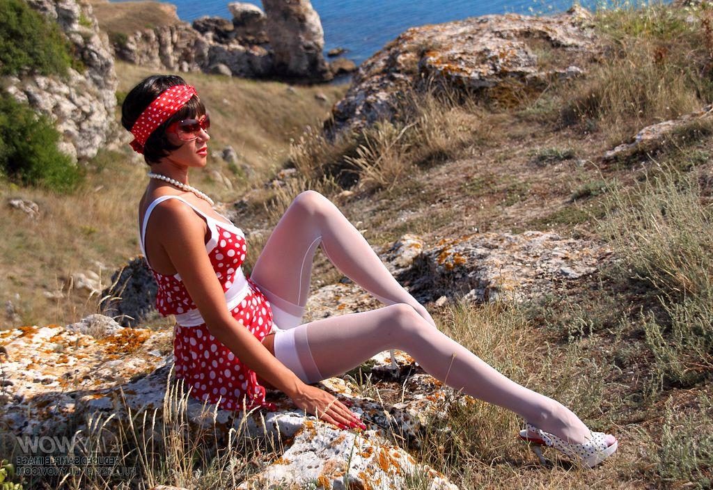 12P Sexy MILF uncovers her breasts on a seaside cliff in white nylons