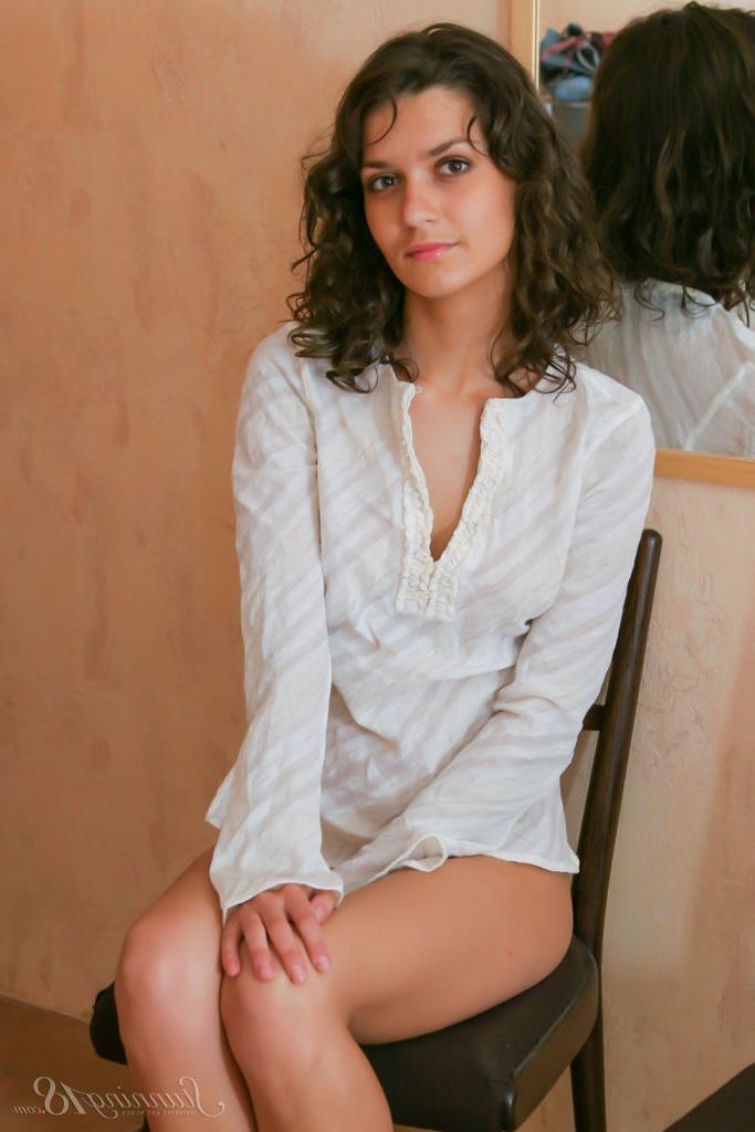 16P Young brunette Roza A highlights her landing strip pussy while going nude