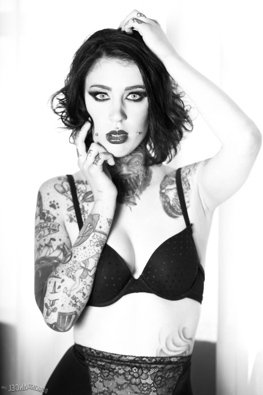 17P Brunette whore shows off her naked tattooed body in a hot black and white solo
