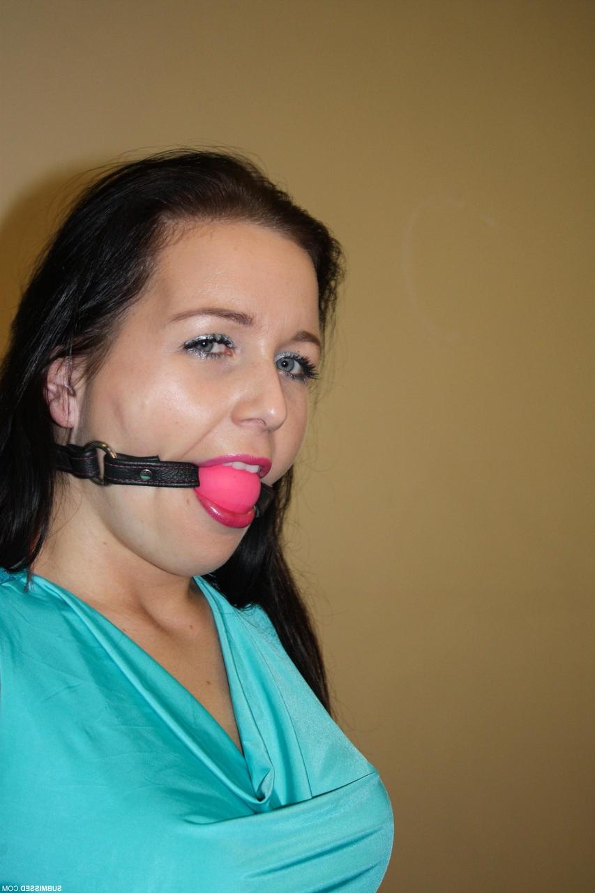 17P Ballgagged brunette is tied to a chair with rope in black pants and heels