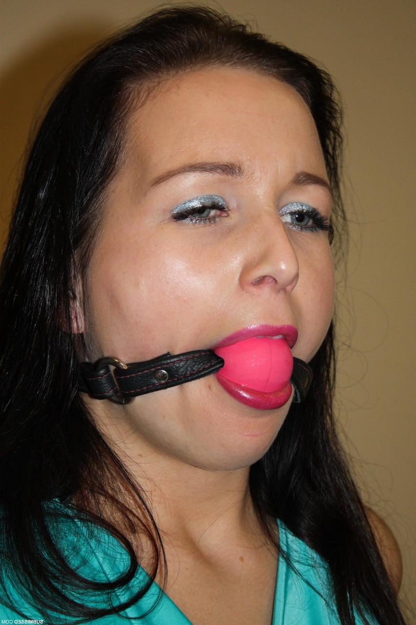 17P Ballgagged brunette is tied to a chair with rope in black pants and heels