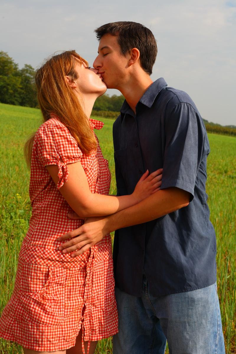 15P Young couple kiss before having sexual intercourse in a field