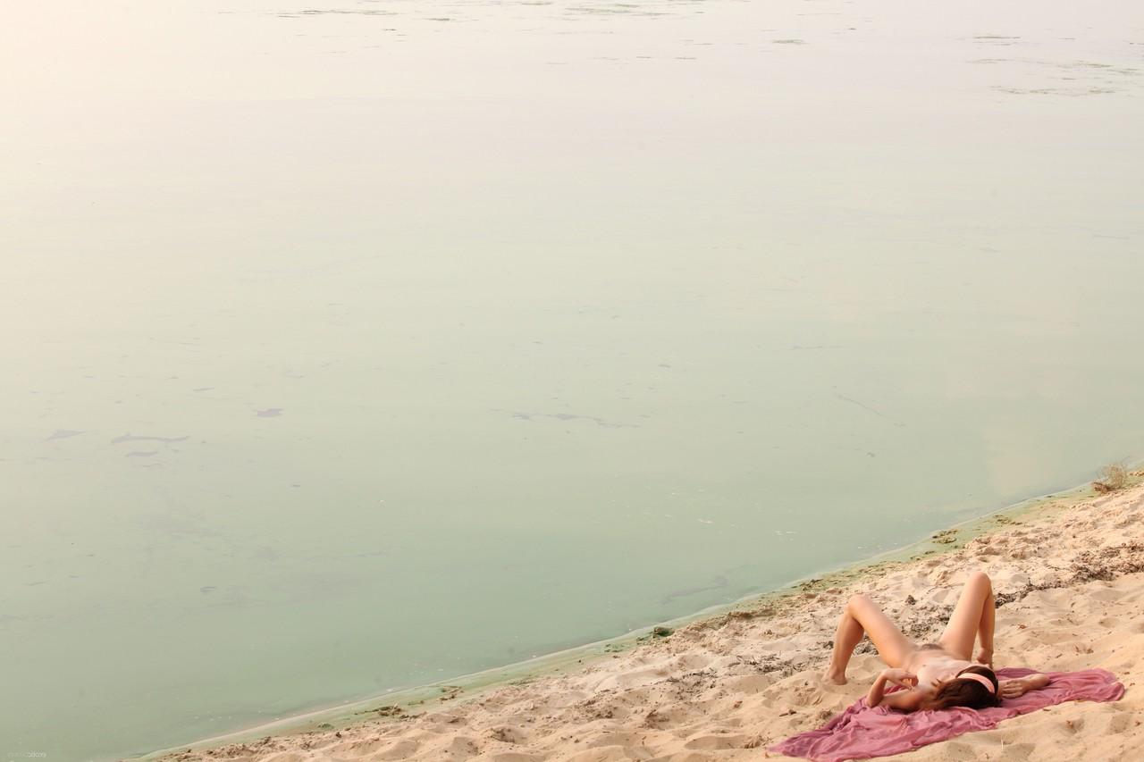 17P At the seaside young red-haired chick with unshaved pussy Arian walks naked