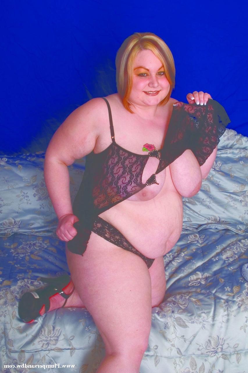 15P Overweight redhead does away with her lingerie before holding her saggy boobs