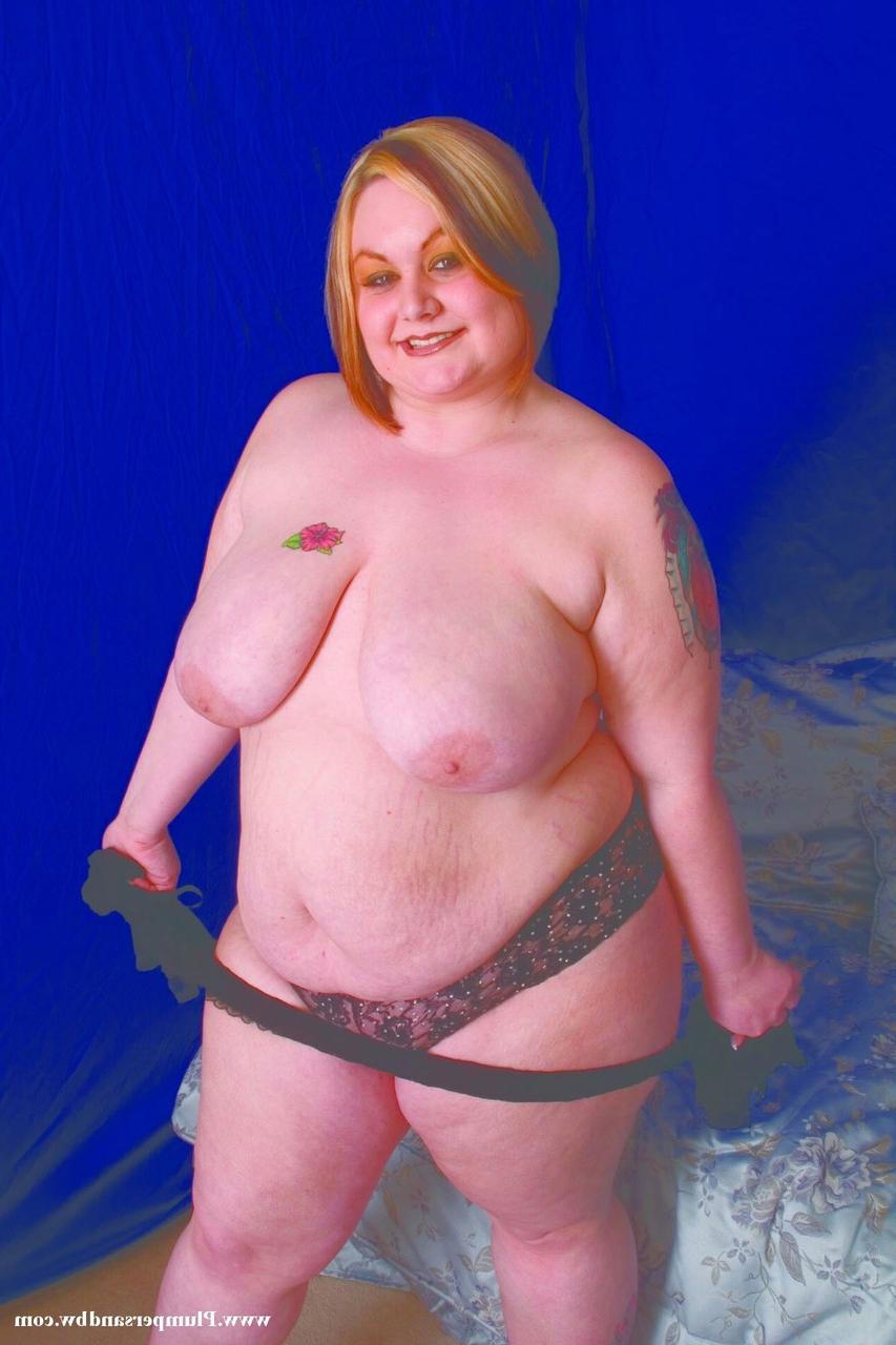 15P Overweight redhead does away with her lingerie before holding her saggy boobs