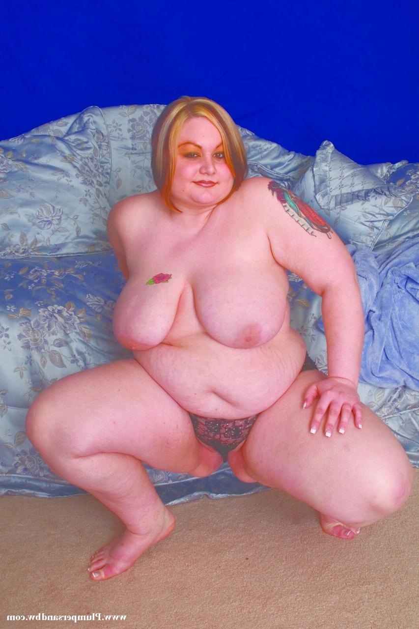 15P Overweight redhead does away with her lingerie before holding her saggy boobs