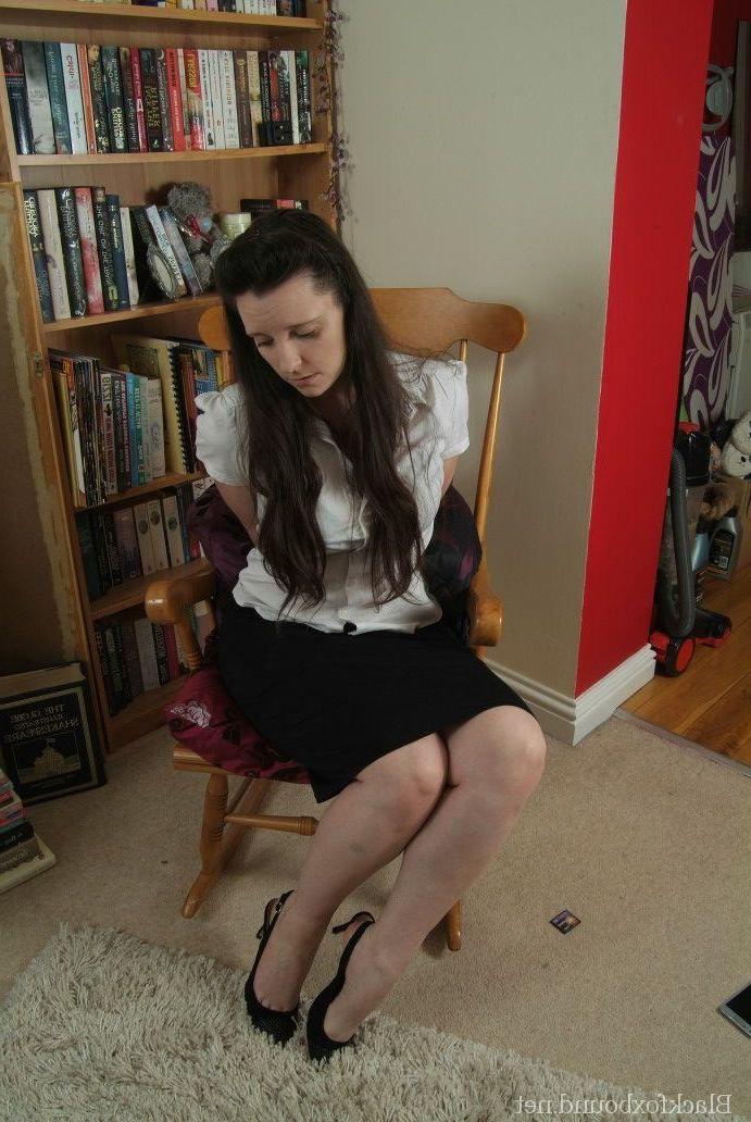 16P Brunette woman struggles against rope bindings in a rocking chair
