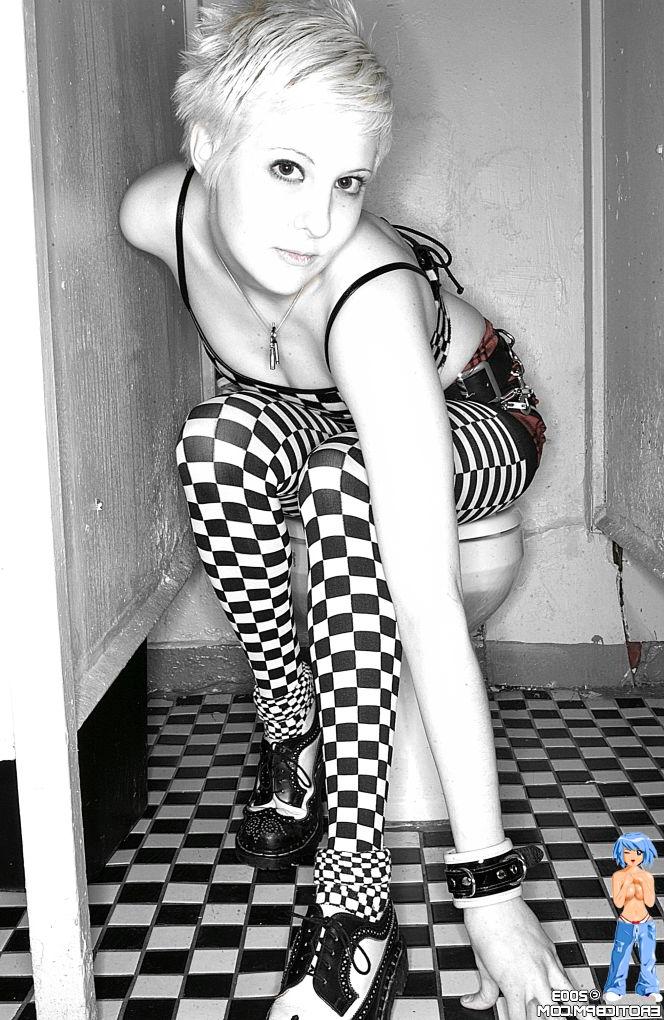15P Sexy girl with short blonde hair Watts disrobes on top of a public toilet