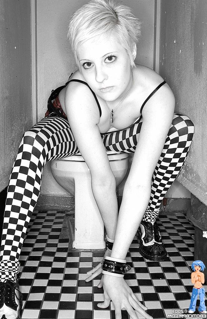 15P Sexy girl with short blonde hair Watts disrobes on top of a public toilet