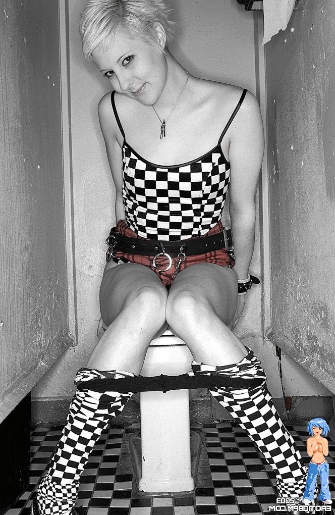 15P Sexy girl with short blonde hair Watts disrobes on top of a public toilet