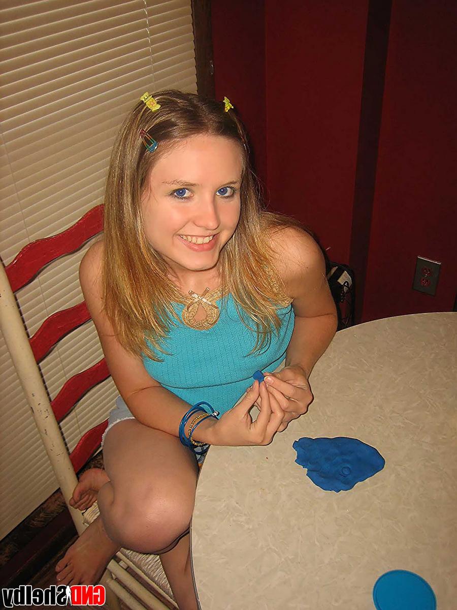 12P Young looking girl gets naked at a kitchen table with barrettes in her hair