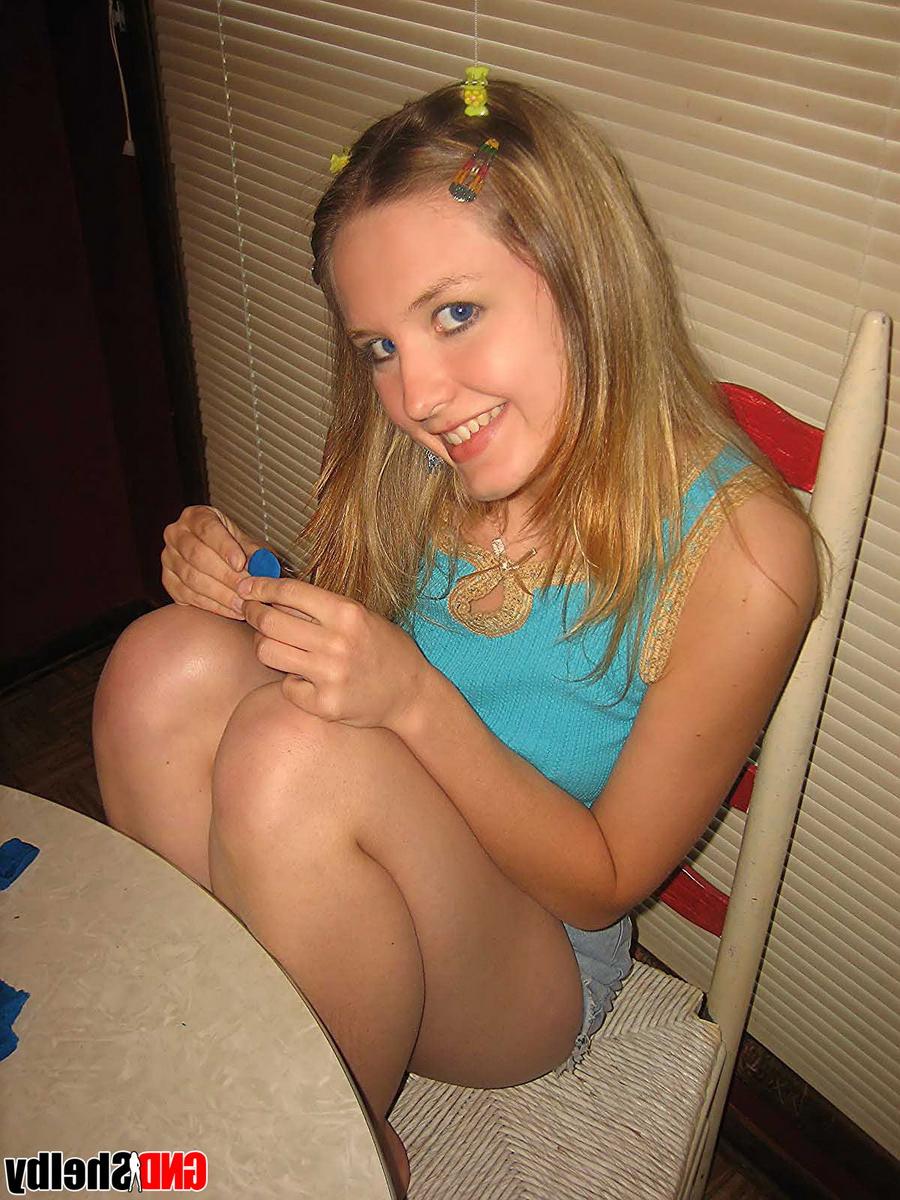 12P Young looking girl gets naked at a kitchen table with barrettes in her hair