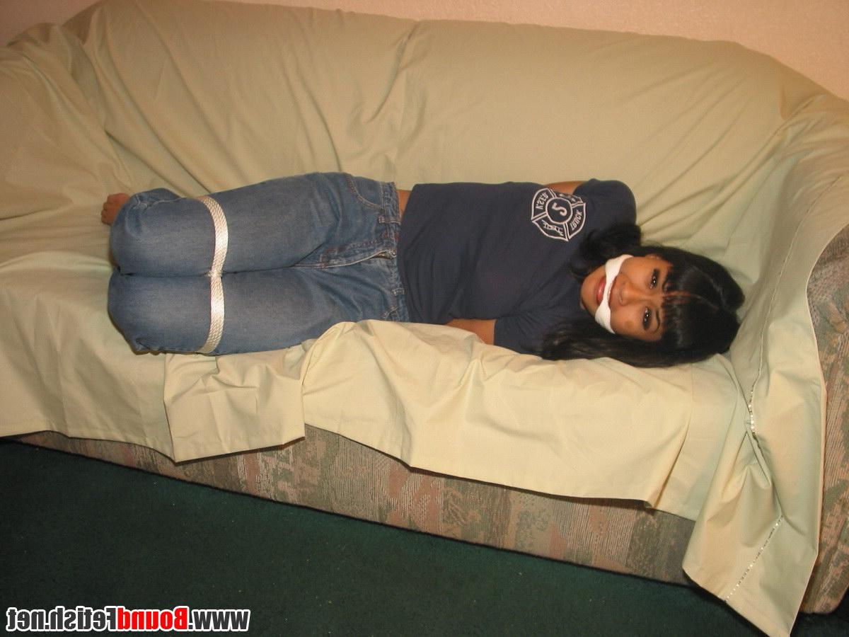 16P Solo girl with painted toenails is hog tied & gagged on a sofa in her clothes