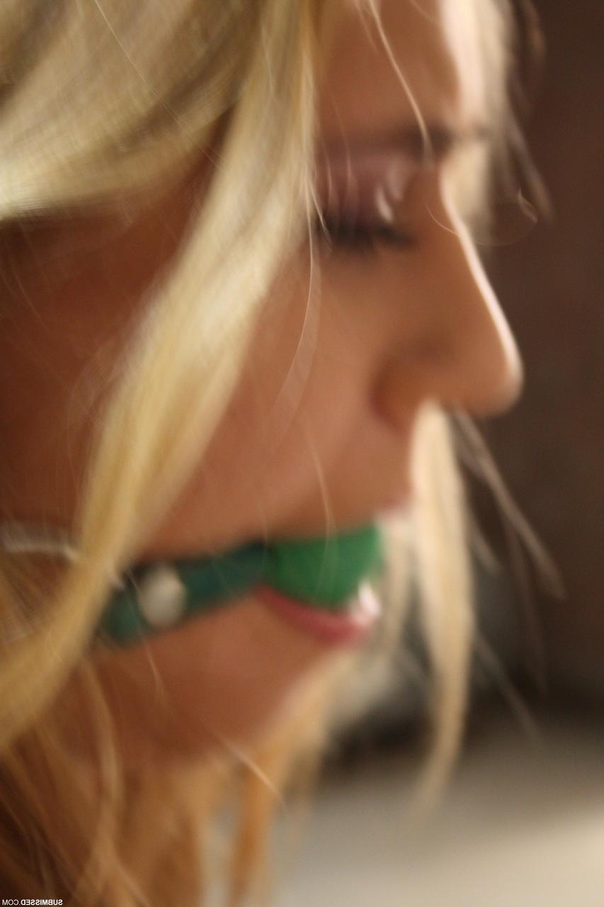 20P Submissive Hungarian Linda Ray has her tits exposed while ball-gagged & bound