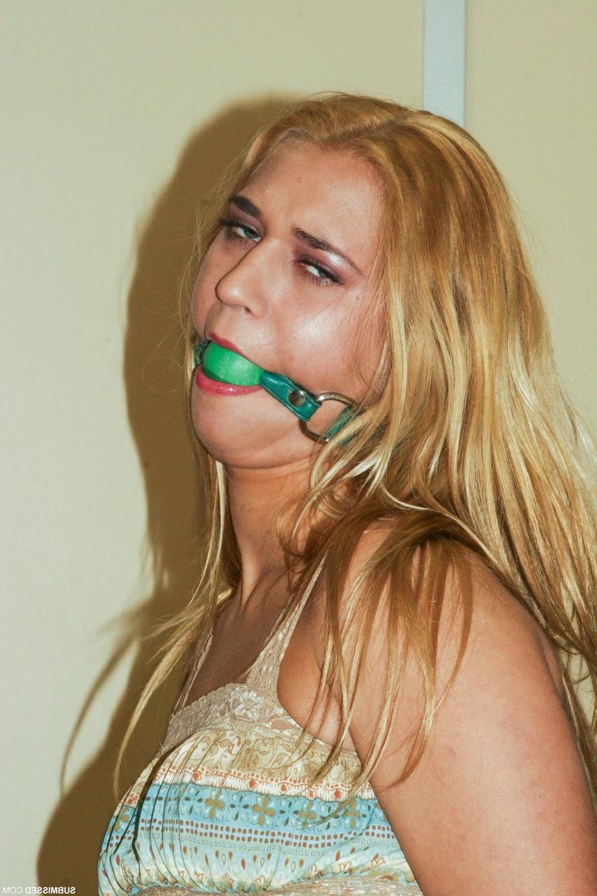 20P Submissive Hungarian Linda Ray has her tits exposed while ball-gagged & bound