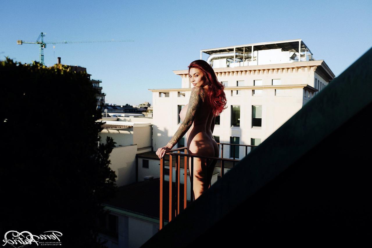 17P Asian MILF Tera Patrick models in the nude during a rooftop shoot