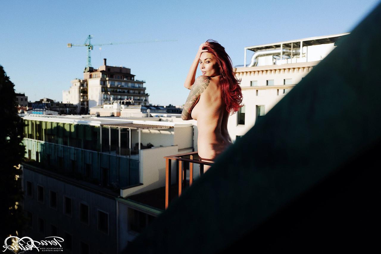 17P Asian MILF Tera Patrick models in the nude during a rooftop shoot